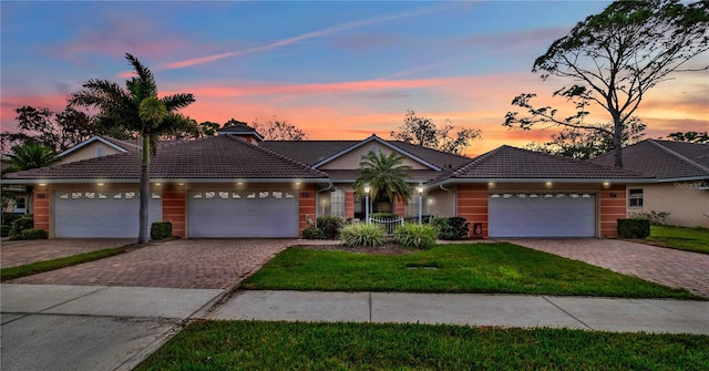 view of front of property with a yard and a garage