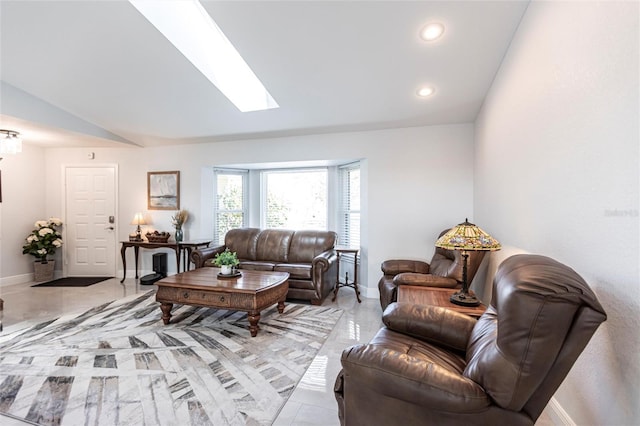 living room with vaulted ceiling with skylight