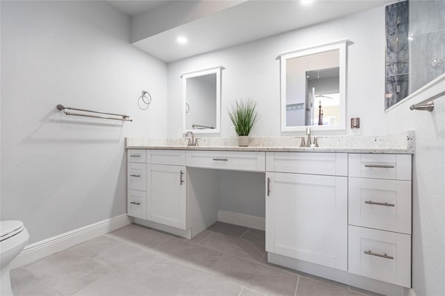 bathroom with tile patterned flooring, vanity, and toilet