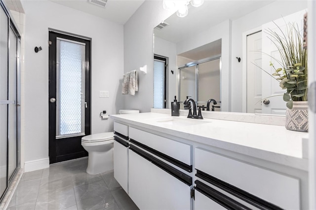 bathroom featuring vanity, an enclosed shower, and toilet