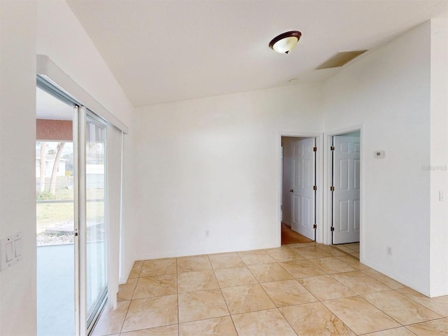 unfurnished room featuring vaulted ceiling