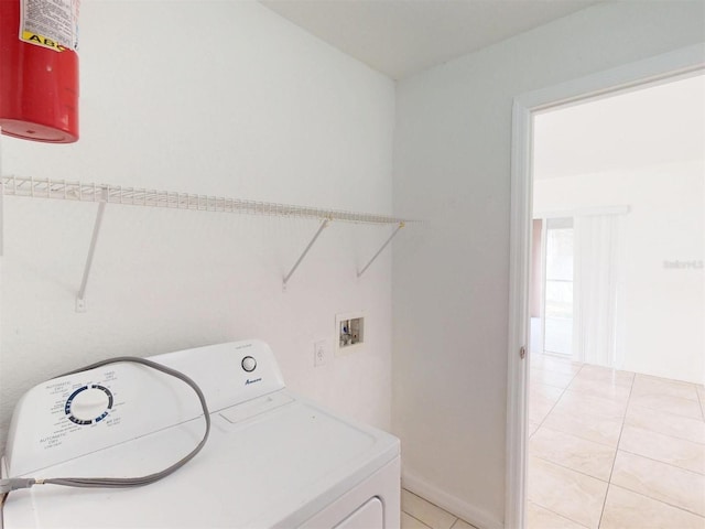 clothes washing area featuring washer / dryer and light tile patterned floors