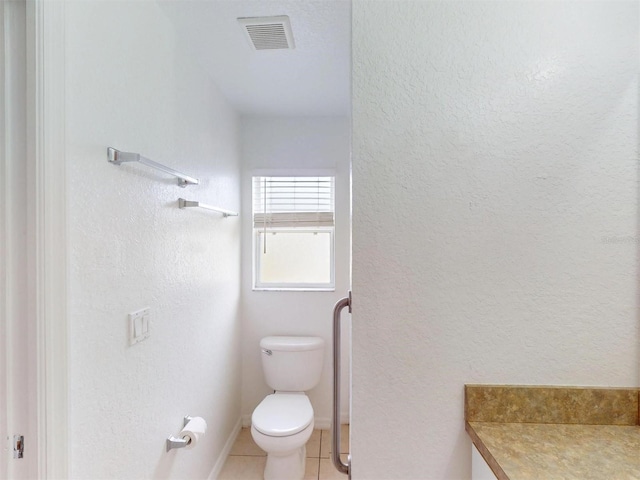 bathroom with tile patterned flooring and toilet