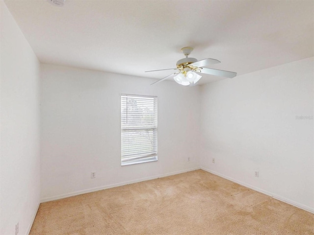 unfurnished room featuring ceiling fan and light colored carpet