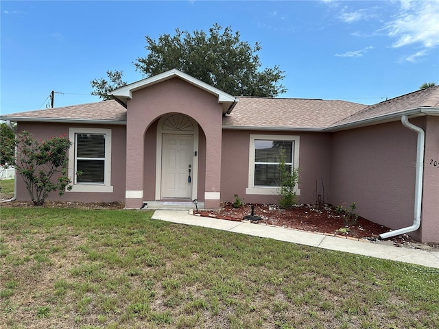 20370 Mount Prospect Ave, Port Charlotte, FL 33952 - ranch-style home featuring stucco siding, a front lawn, and a shingled roof