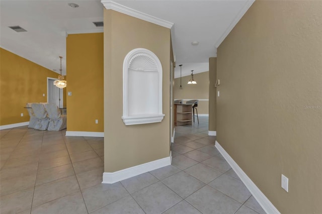 295 Porto Alegre St, Punta Gorda, FL 33983 - hallway featuring light tile patterned flooring, vaulted ceiling, ornamental molding, and a notable chandelier