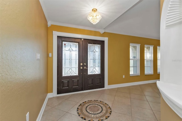295 Porto Alegre St, Punta Gorda, FL 33983 - tiled entrance foyer featuring an inviting chandelier, lofted ceiling, ornamental molding, and french doors