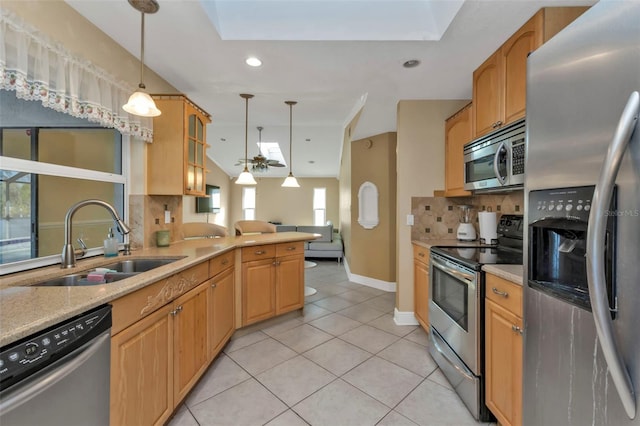 295 Porto Alegre St, Punta Gorda, FL 33983 - kitchen featuring sink, vaulted ceiling, appliances with stainless steel finishes, pendant lighting, and backsplash