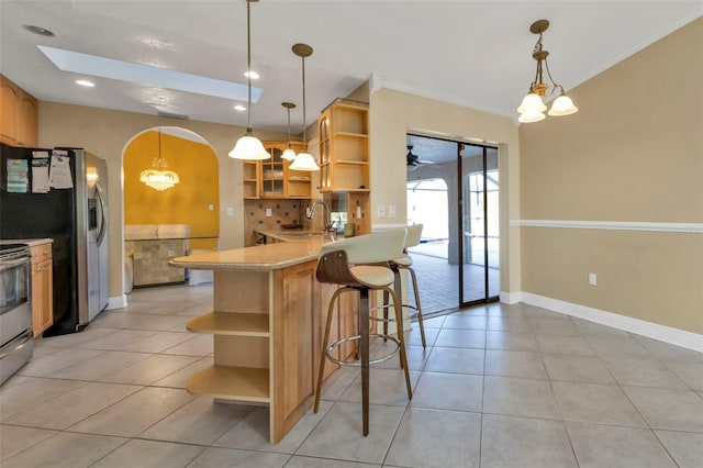 295 Porto Alegre St, Punta Gorda, FL 33983 - kitchen featuring pendant lighting, sink, a breakfast bar area, appliances with stainless steel finishes, and kitchen peninsula