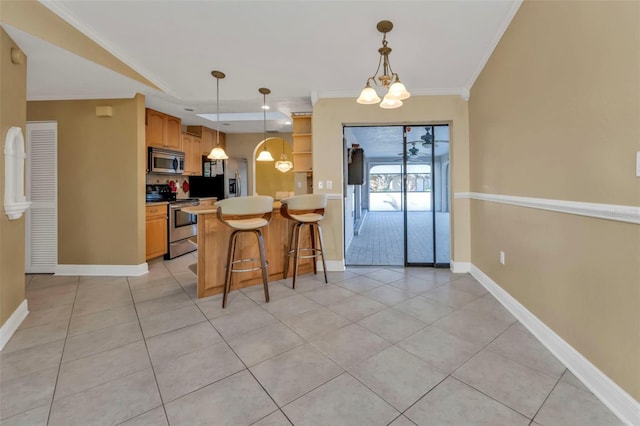 295 Porto Alegre St, Punta Gorda, FL 33983 - kitchen featuring appliances with stainless steel finishes, a kitchen breakfast bar, hanging light fixtures, light tile patterned floors, and crown molding