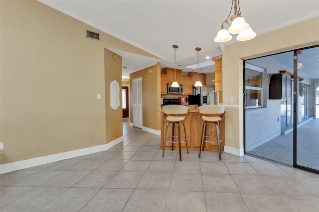 295 Porto Alegre St, Punta Gorda, FL 33983 - kitchen with crown molding, decorative light fixtures, a breakfast bar area, and stainless steel appliances