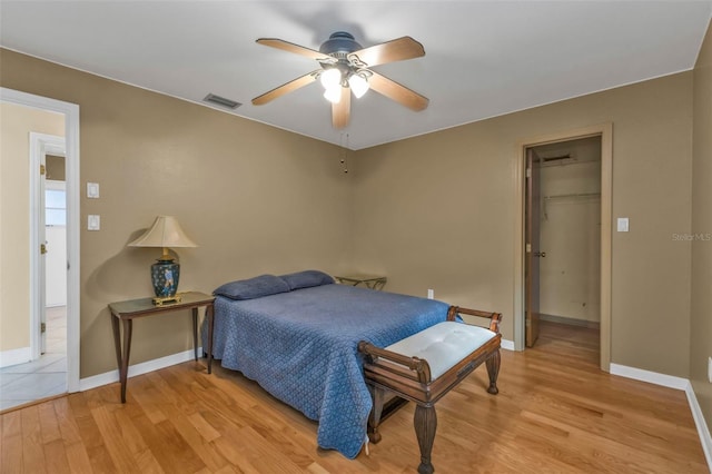 295 Porto Alegre St, Punta Gorda, FL 33983 - bedroom with a walk in closet, a closet, ceiling fan, and light wood-type flooring