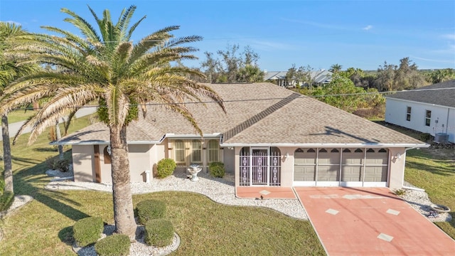 295 Porto Alegre St, Punta Gorda, FL 33983 - view of front of property with a garage, a front yard, and central AC unit
