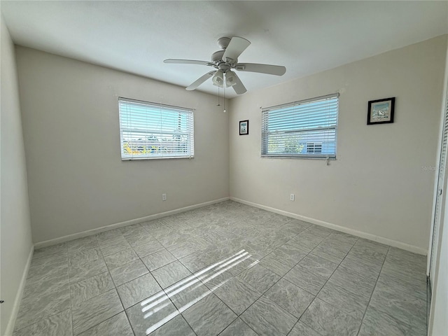 unfurnished room featuring plenty of natural light and ceiling fan