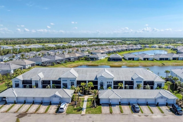 drone / aerial view featuring a residential view and a water view