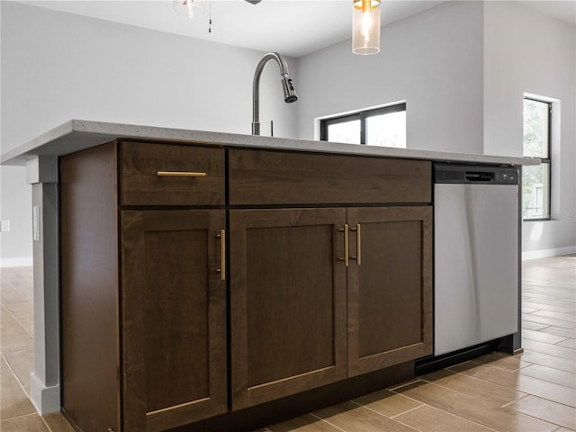 1818 New London St, North Port, FL 34288 - kitchen view of stainless steel dishwasher, dark brown cabinetry, wood finish floors, and ceiling fan
