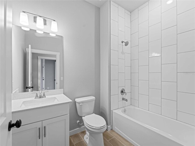 1818 New London St, North Port, FL 34288 - full bath with vanity, toilet, wood finish floors, shower / washtub combination, and baseboards
