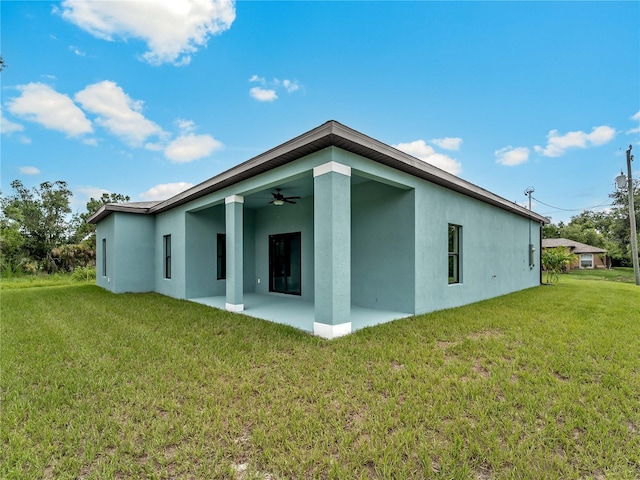 1818 New London St, North Port, FL 34288 - rear view of property with ceiling fan, a patio, stucco siding, and a lawn