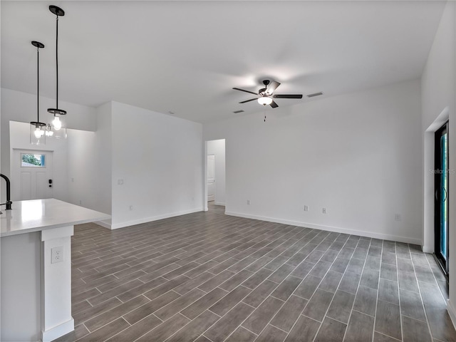1818 New London St, North Port, FL 34288 - unfurnished living room featuring a ceiling fan and dark wood-style flooring