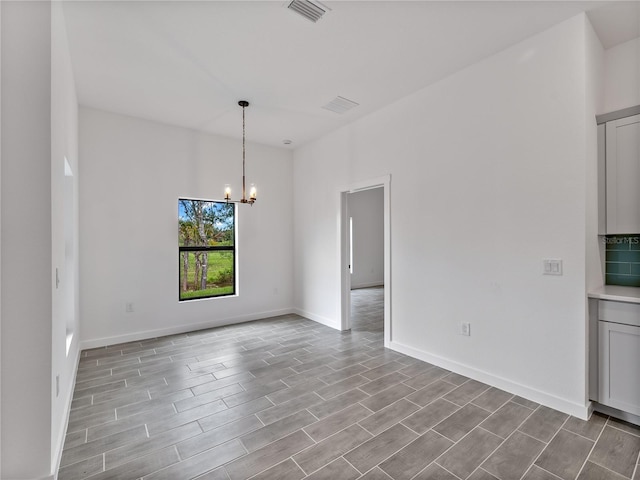 1818 New London St, North Port, FL 34288 - spare room with a chandelier and wood finished floors