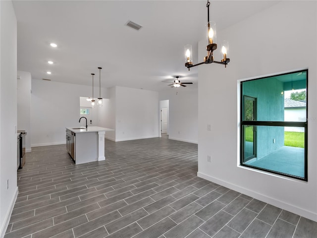 1818 New London St, North Port, FL 34288 - kitchen with a chandelier, open floor plan, ceiling fan, light countertops, and recessed lighting
