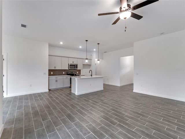 1818 New London St, North Port, FL 34288 - kitchen with open floor plan, recessed lighting, appliances with stainless steel finishes, ceiling fan, and a kitchen island with sink