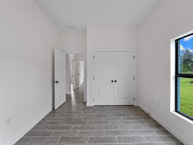 1818 New London St, North Port, FL 34288 - unfurnished bedroom featuring a closet and wood finished floors