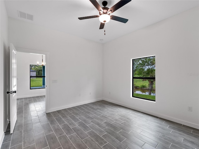 1818 New London St, North Port, FL 34288 - empty room with a chandelier, a ceiling fan, and dark wood finished floors