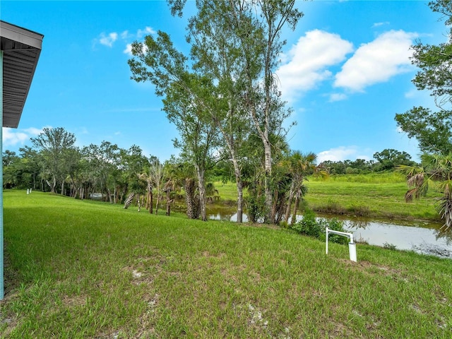 1818 New London St, North Port, FL 34288 - view of grassy yard featuring a water view and view of wooded area