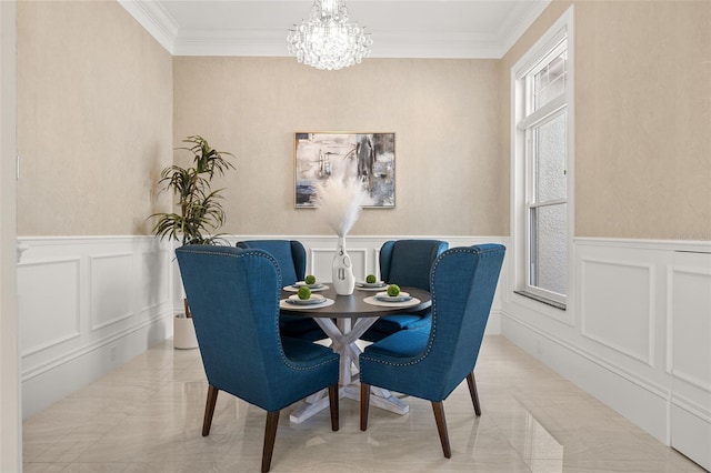 dining space with ornamental molding and a chandelier