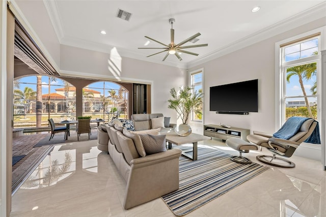 living room with ceiling fan and ornamental molding