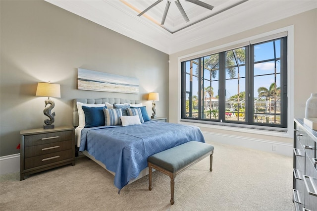 bedroom featuring crown molding, light colored carpet, a raised ceiling, and ceiling fan