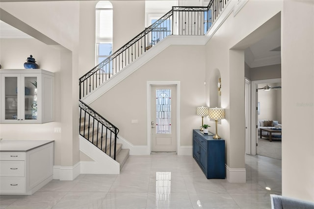 entryway featuring a high ceiling and crown molding