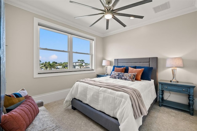 carpeted bedroom featuring crown molding and ceiling fan