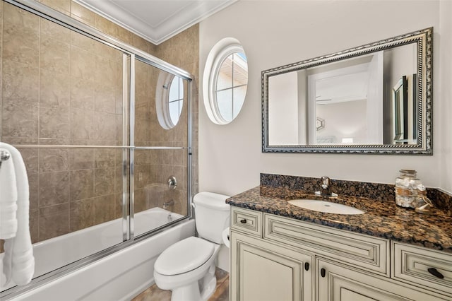 full bathroom featuring vanity, toilet, crown molding, and shower / bath combination with glass door