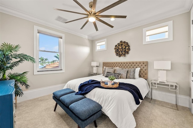 carpeted bedroom featuring ceiling fan and ornamental molding