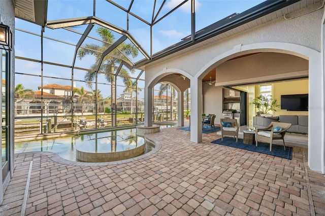 view of swimming pool featuring ceiling fan, an outdoor living space, a patio area, and glass enclosure