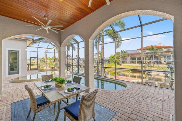 sunroom featuring a water view and wood ceiling