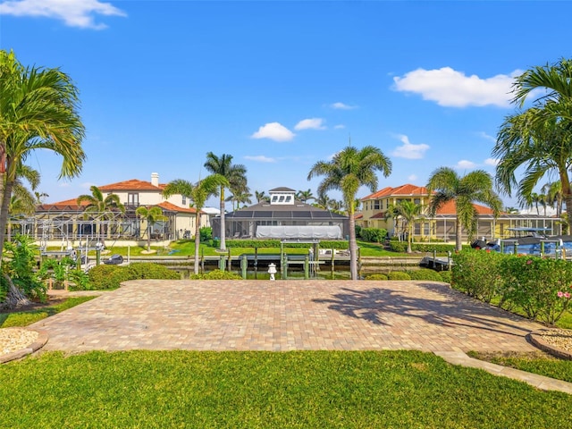 view of property's community featuring a lawn and a boat dock