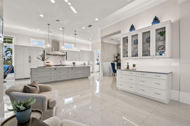 interior space featuring ornamental molding, vanity, and decorative backsplash