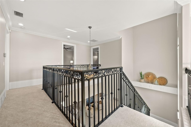 hallway with light carpet and crown molding