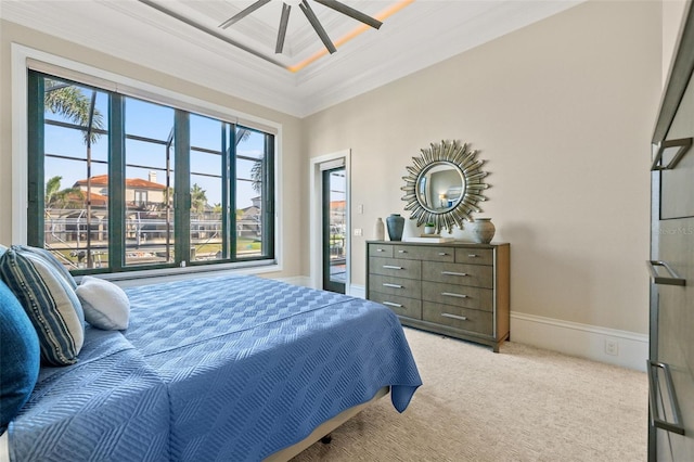 carpeted bedroom featuring ceiling fan, ornamental molding, access to exterior, and a raised ceiling