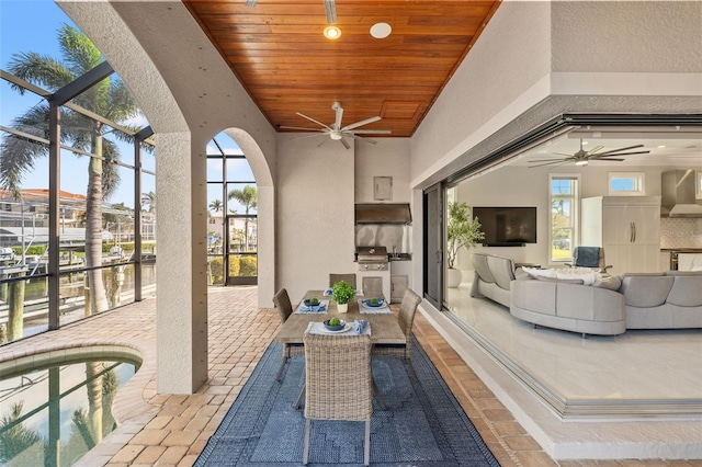 view of patio with an outdoor kitchen, a grill, an outdoor hangout area, and ceiling fan