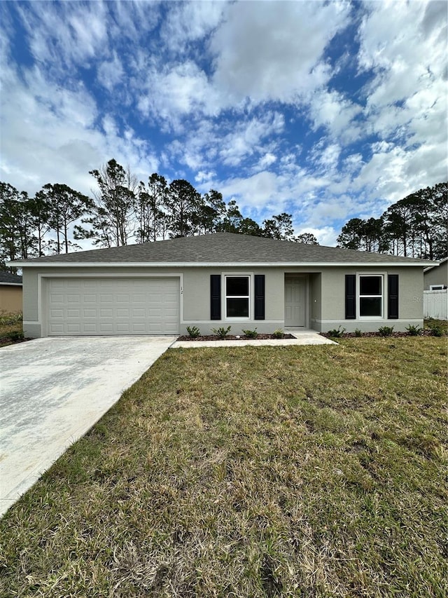 ranch-style home featuring driveway, an attached garage, a front yard, and stucco siding