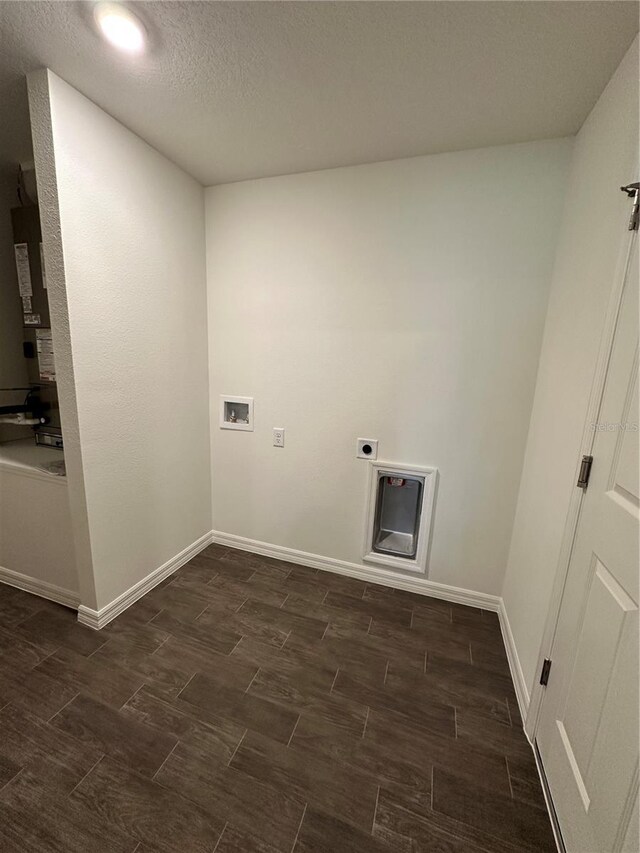 laundry room with wood finish floors, washer hookup, and baseboards