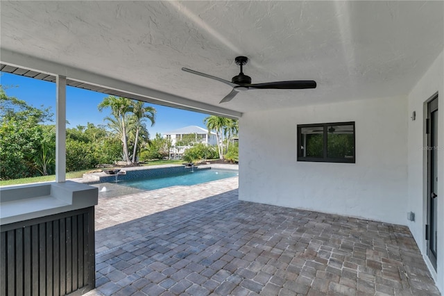 exterior space with ceiling fan and pool water feature