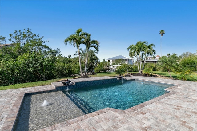 view of swimming pool with pool water feature and a patio area