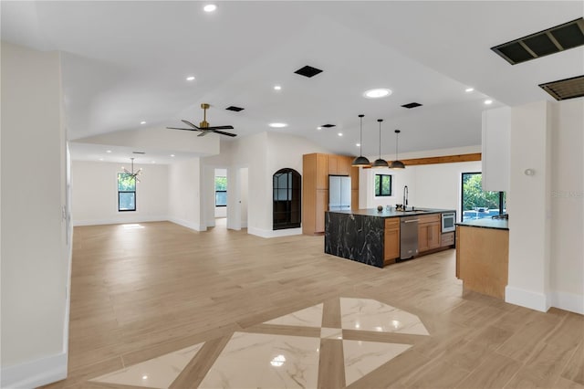 kitchen with sink, stainless steel dishwasher, vaulted ceiling, white fridge, and pendant lighting