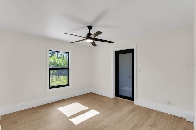 empty room featuring ceiling fan and light hardwood / wood-style floors