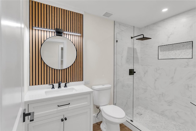 bathroom with vanity, toilet, a shower with shower door, and hardwood / wood-style floors